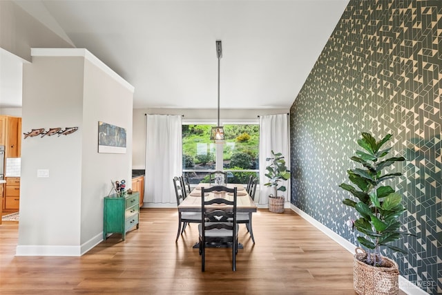 471 Dungeness Dr, Fox Island, WA 98333 - dining area with wallpapered walls, baseboards, an accent wall, and light wood finished floors