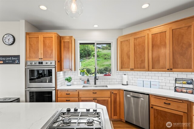 471 Dungeness Dr, Fox Island, WA 98333 - kitchen featuring a sink, appliances with stainless steel finishes, tasteful backsplash, recessed lighting, and brown cabinets
