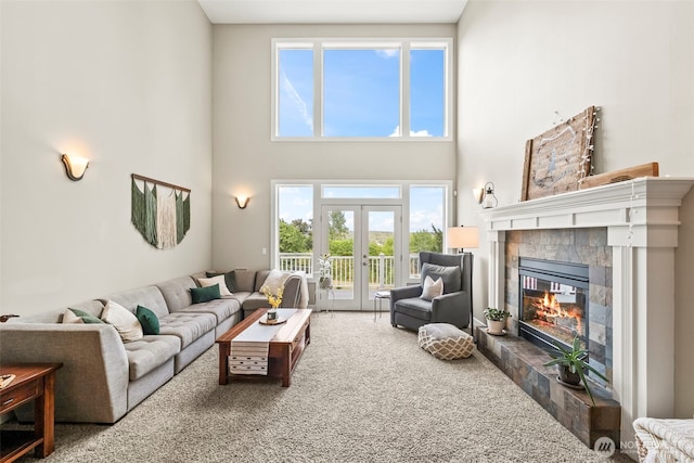 471 Dungeness Dr, Fox Island, WA 98333 - living area featuring a fireplace, carpet floors, a high ceiling, and french doors