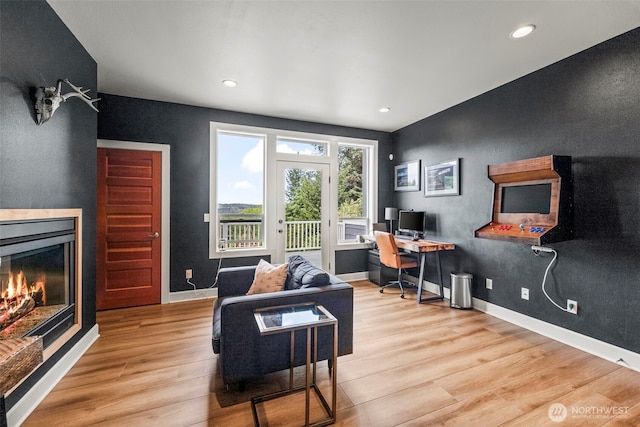 471 Dungeness Dr, Fox Island, WA 98333 - office area with wood finished floors, a glass covered fireplace, recessed lighting, and baseboards