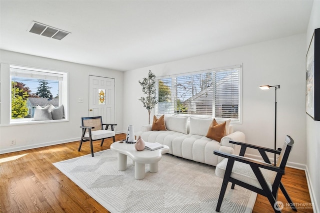 10229 35th Ave SW, Seattle, WA 98146 - living room featuring plenty of natural light, wood finished floors, and baseboards