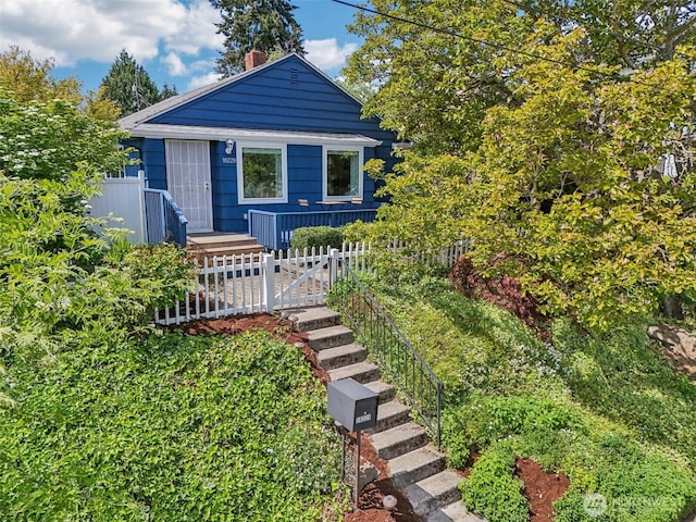 10229 35th Ave SW, Seattle, WA 98146 - bungalow-style home with a chimney and a fenced front yard