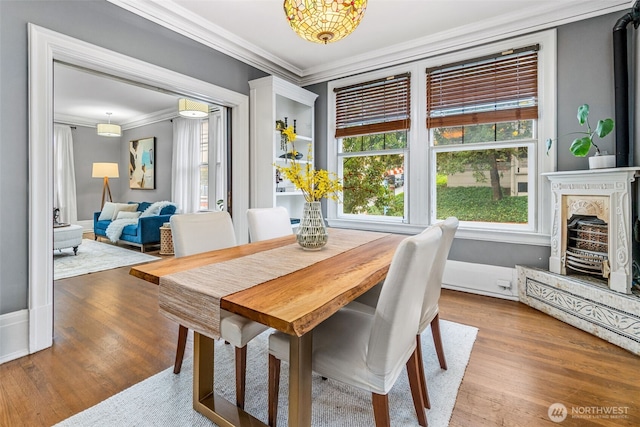 615 Boren Ave Unit 11, Seattle, WA 98104 - dining space featuring ornamental molding, healthy amount of natural light, and wood finished floors