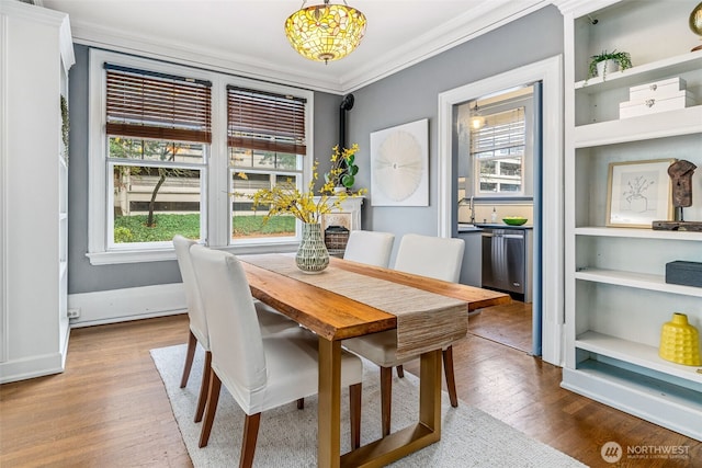 615 Boren Ave Unit 11, Seattle, WA 98104 - dining area with ornamental molding, healthy amount of natural light, wood finished floors, and baseboards