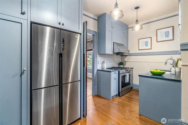 615 Boren Ave Unit 11, Seattle, WA 98104 - kitchen with stainless steel appliances, ventilation hood, light wood-style flooring, dark countertops, and tasteful backsplash