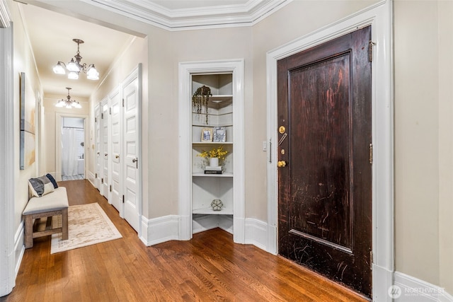 615 Boren Ave Unit 11, Seattle, WA 98104 - entryway with a chandelier, wood finished floors, ornamental molding, and baseboards
