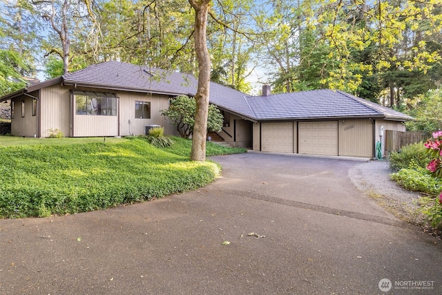 14930 15th Avenue Ct E, Tacoma, WA 98445 - ranch-style home with an attached garage, driveway, and a chimney