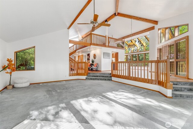 14930 15th Avenue Ct E, Tacoma, WA 98445 - unfurnished living room featuring carpet, baseboards, high vaulted ceiling, plenty of natural light, and beamed ceiling