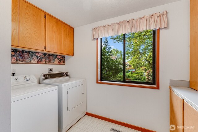 14930 15th Avenue Ct E, Tacoma, WA 98445 - washroom featuring cabinet space, washer and clothes dryer, baseboards, and light tile patterned floors