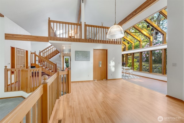 14930 15th Avenue Ct E, Tacoma, WA 98445 - entrance foyer with high vaulted ceiling, wood finished floors, baseboards, and beamed ceiling