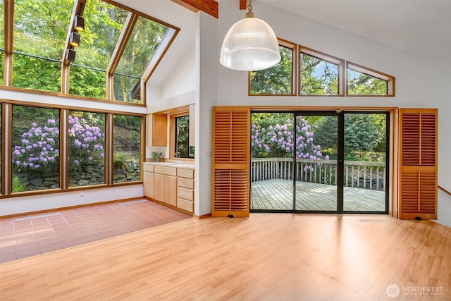 14930 15th Avenue Ct E, Tacoma, WA 98445 - unfurnished living room with high vaulted ceiling, light wood finished floors, and baseboards