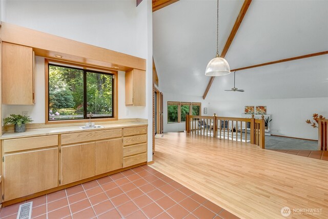 14930 15th Avenue Ct E, Tacoma, WA 98445 - kitchen featuring high vaulted ceiling, light countertops, beam ceiling, light brown cabinets, and a sink