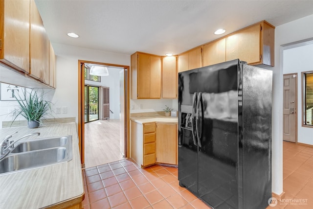 14930 15th Avenue Ct E, Tacoma, WA 98445 - kitchen with black fridge with ice dispenser, a sink, light countertops, light tile patterned flooring, and recessed lighting
