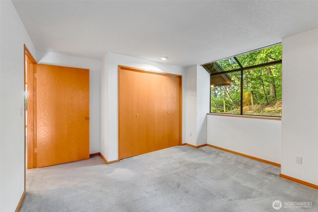14930 15th Avenue Ct E, Tacoma, WA 98445 - unfurnished bedroom with baseboards, carpet flooring, and a closet