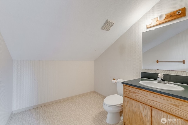 14930 15th Avenue Ct E, Tacoma, WA 98445 - bathroom featuring lofted ceiling, toilet, vanity, and baseboards