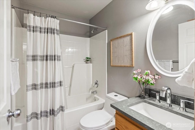 bathroom featuring shower / tub combo, vanity, and toilet