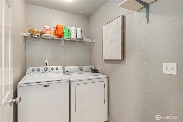 clothes washing area with washing machine and dryer