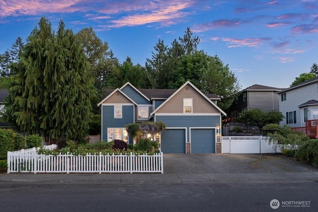 view of front of home with asphalt driveway and a garage