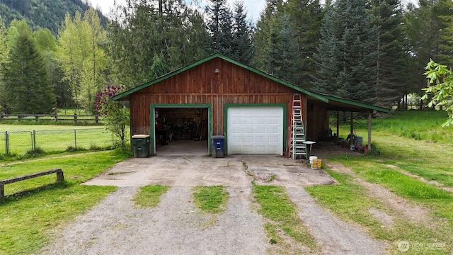 588 Mineral Creek Rd, Mineral, WA 98355 - garage featuring a view of trees, driveway, and a garage