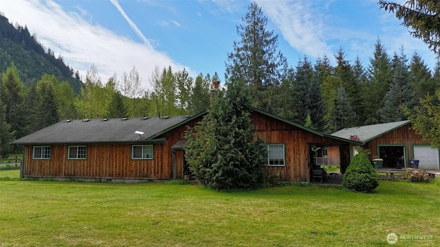 588 Mineral Creek Rd, Mineral, WA 98355 - rear view of house with a lawn, a forest view, a garage, and a chimney