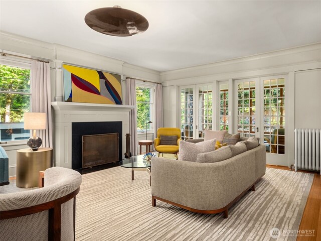 2161 E Interlaken Blvd, Seattle, WA 98112 - living room with radiator heating unit, a fireplace with flush hearth, crown molding, and wood finished floors