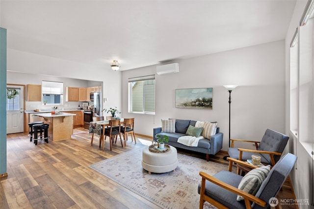 19554 Jensen Way NE, Poulsbo, WA 98370 - living area featuring an AC wall unit and light wood-style flooring