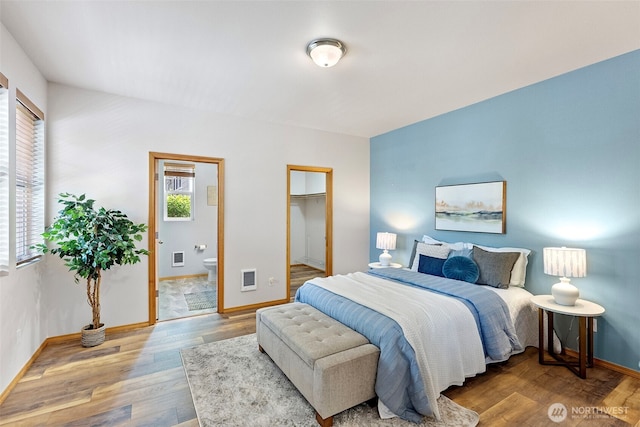 19554 Jensen Way NE, Poulsbo, WA 98370 - bedroom with baseboards, wood finished floors, a spacious closet, and ensuite bath