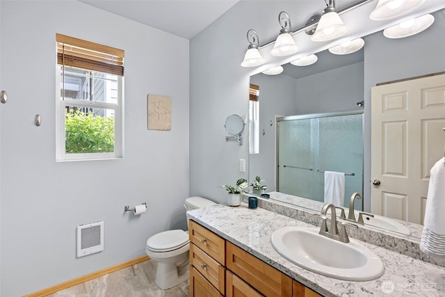 19554 Jensen Way NE, Poulsbo, WA 98370 - bathroom featuring baseboards, heating unit, a stall shower, vanity, and toilet