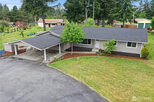 19045 Nutmeg St SW, Rochester, WA 98579 - single story home with roof with shingles, a front lawn, a carport, asphalt driveway, and view of scattered trees