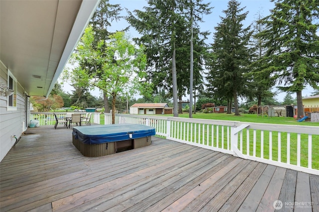 19045 Nutmeg St SW, Rochester, WA 98579 - deck featuring a covered hot tub, a playground, a lawn, outdoor dining area, and a storage shed