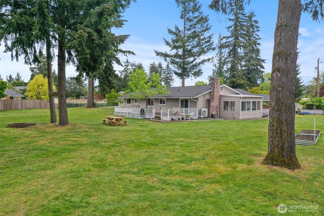 19045 Nutmeg St SW, Rochester, WA 98579 - rear view of property with a chimney and a wooden deck