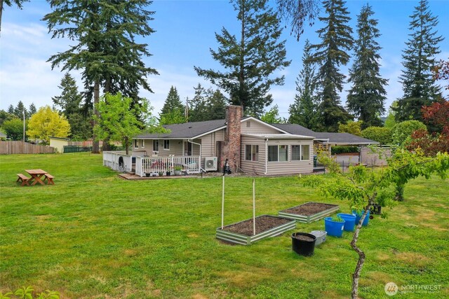 19045 Nutmeg St SW, Rochester, WA 98579 - back of property featuring a garden, a chimney, and a deck