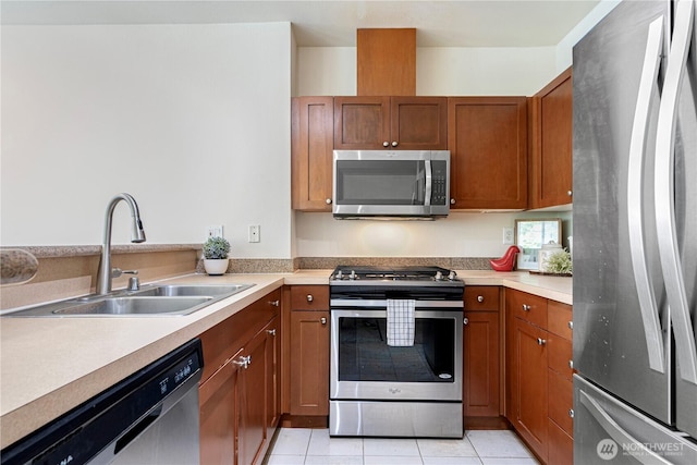1000 Aurora Ave N Unit 311, Seattle, WA 98109 - kitchen with appliances with stainless steel finishes, a sink, brown cabinetry, light countertops, and light tile patterned flooring