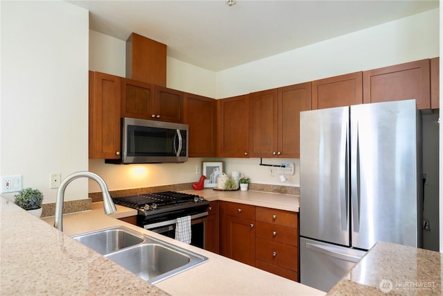 1000 Aurora Ave N Unit 311, Seattle, WA 98109 - kitchen featuring stainless steel appliances, light countertops, a sink, and brown cabinetry