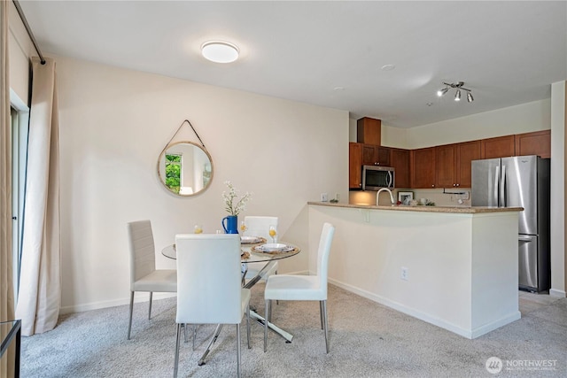 1000 Aurora Ave N Unit 311, Seattle, WA 98109 - dining room featuring light colored carpet and baseboards