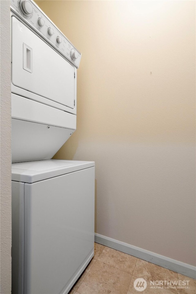1000 Aurora Ave N Unit 311, Seattle, WA 98109 - laundry room with stacked washer / drying machine, baseboards, and light tile patterned flooring