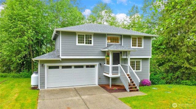 12605 Monte Cristo Way, Granite Falls, WA 98252 - bi-level home with driveway, a front lawn, a garage, and roof with shingles
