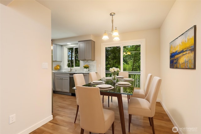 12605 Monte Cristo Way, Granite Falls, WA 98252 - dining room featuring baseboards, light wood-style floors, and a chandelier