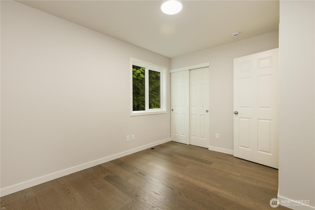 12605 Monte Cristo Way, Granite Falls, WA 98252 - unfurnished bedroom featuring baseboards, wood finished floors, and a closet