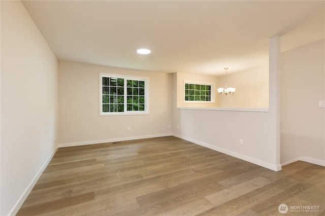 12605 Monte Cristo Way, Granite Falls, WA 98252 - empty room featuring a chandelier, wood finished floors, baseboards, and recessed lighting