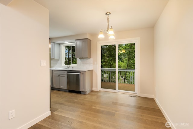 12605 Monte Cristo Way, Granite Falls, WA 98252 - kitchen featuring gray cabinetry, dishwasher, a chandelier, light countertops, and tasteful backsplash