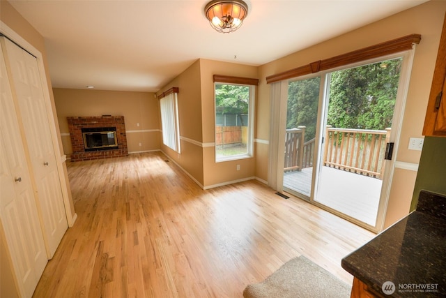 11857SE 321st Pl, Auburn, WA 98092 - unfurnished living room with light wood-style flooring, baseboards, and a fireplace