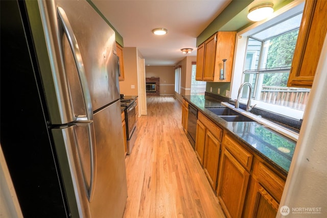 11857SE 321st Pl, Auburn, WA 98092 - kitchen with freestanding refrigerator, electric range oven, light wood-style floors, a sink, and brown cabinets