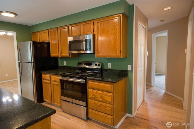 11857SE 321st Pl, Auburn, WA 98092 - kitchen with stainless steel appliances, light wood-type flooring, baseboards, and brown cabinets