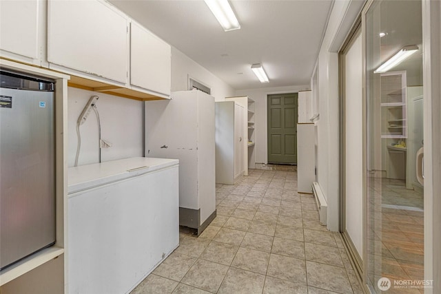 255 Alder St, Orcas Island, WA 98245 - laundry room with baseboard heating and light tile patterned flooring