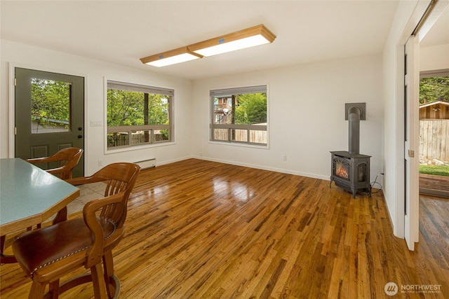 255 Alder St, Orcas Island, WA 98245 - office space featuring a baseboard radiator, wood finished floors, a wood stove, and baseboards