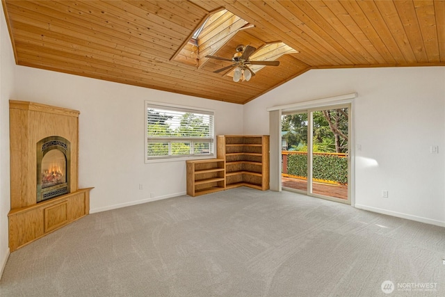 255 Alder St, Orcas Island, WA 98245 - unfurnished living room featuring wood ceiling, a skylight, plenty of natural light, vaulted ceiling, and a warm lit fireplace