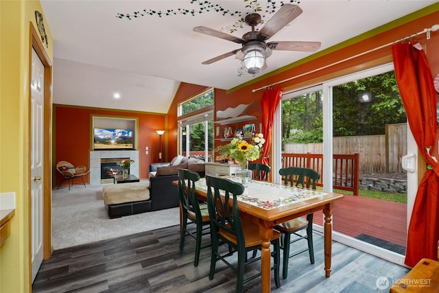 202 170th Pl SE, Bothell, WA 98012 - dining area featuring wood finished floors, lofted ceiling, a tiled fireplace, and a ceiling fan