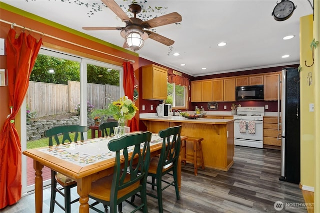 202 170th Pl SE, Bothell, WA 98012 - kitchen with gas range gas stove, black microwave, freestanding refrigerator, a peninsula, and light countertops
