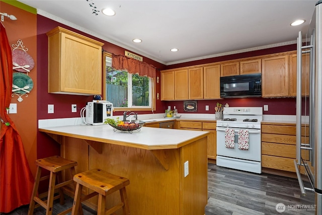 202 170th Pl SE, Bothell, WA 98012 - kitchen featuring black microwave, white gas stove, a peninsula, light countertops, and a sink